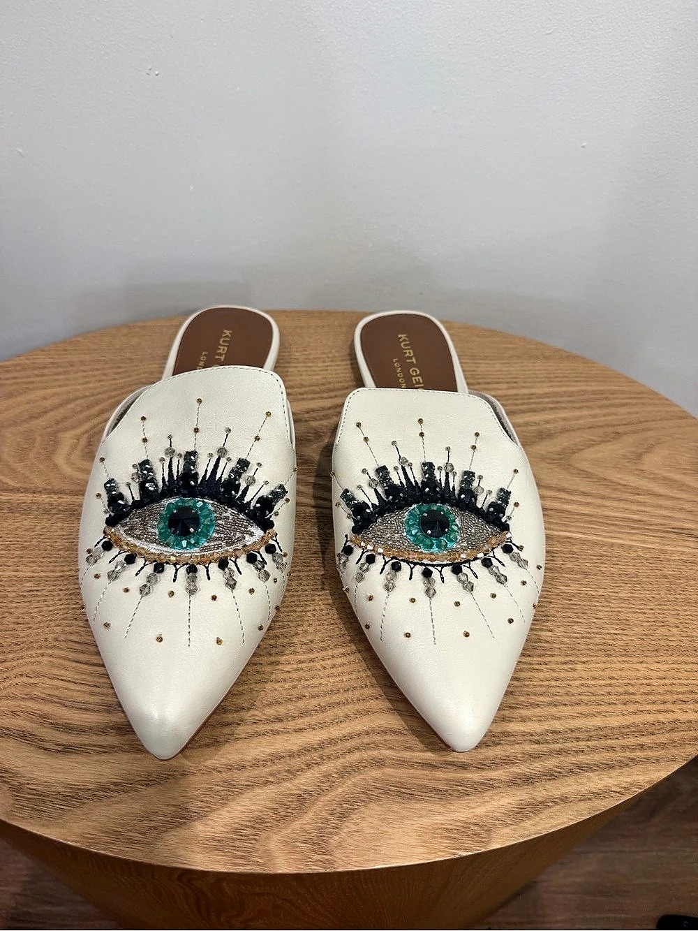 Kurt Geiger White Leather
Pointed Mules with Green Eye Embellishment